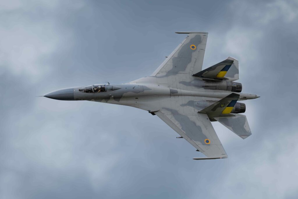 a fighter jet flies through the sky