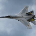 a fighter jet flies through the sky