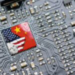 Flag of USA and China on a processor, CPU or GPU microchip on a motherboard. US companies have become the latest collateral damage in US - China tech war. US limits, restricts AI chips sales to China.